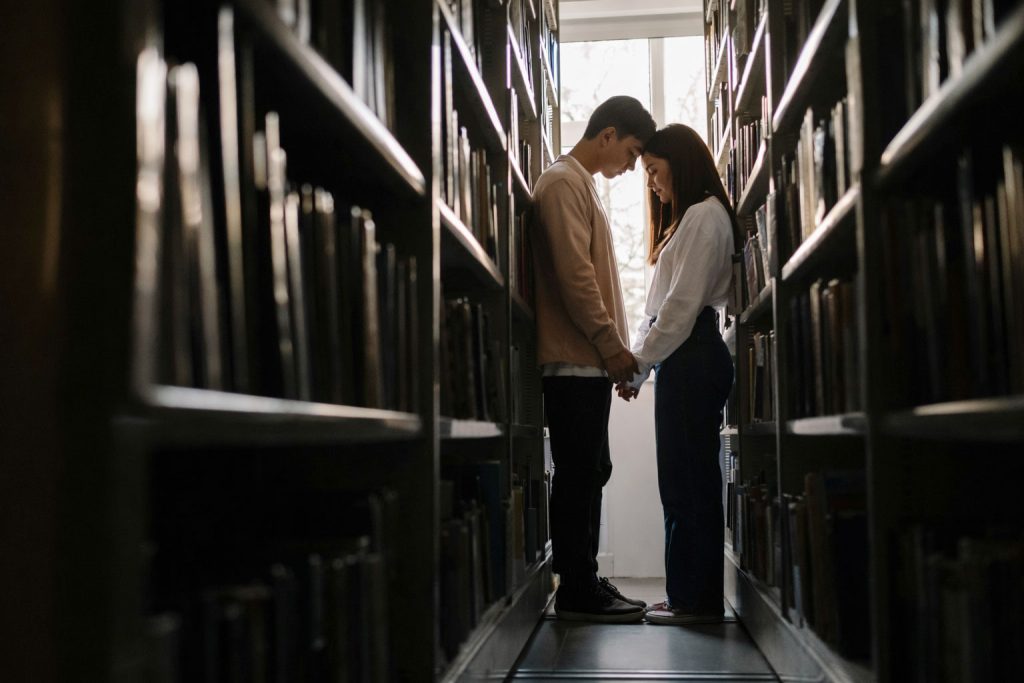 Filipino couple in a warm-lit room expressing sapiosexual attraction through emotional and intellectual connection