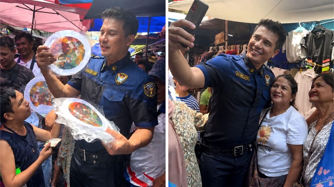 Actor Ejay Falcon distributes merchandise and takes selfies with fans during a crowded Divisoria market appearance.