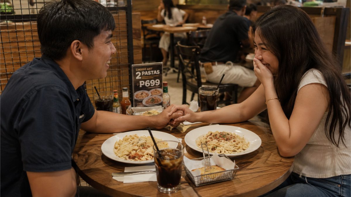 Filipino couple reading restaurant menus while deciding what food to order