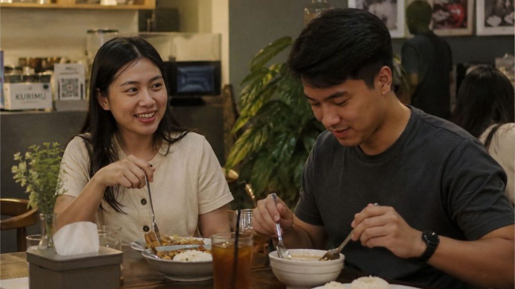 Filipino couple enjoying dinner conversation in a cozy restaurant