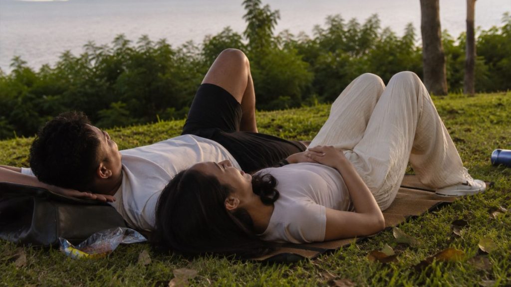 Filipino couple relaxing together outdoors during sunset