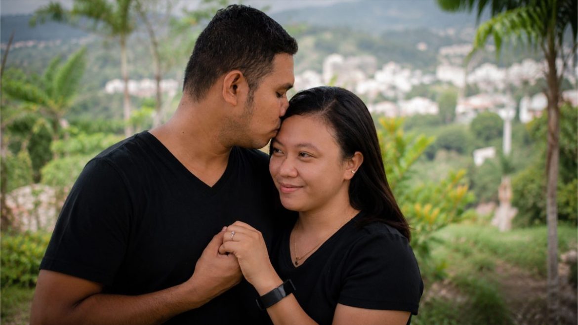 Filipino couple sharing a quiet affectionate moment outdoors while holding hands