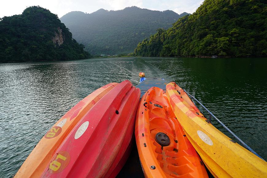 Colorful kayaks floating on Ba Be Lake inside Ba Be National Park, Bac Kan Province, Vietnam.