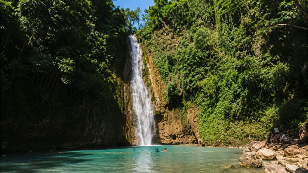 Tropical waterfall in Cebu surrounded by dense forest and clear water