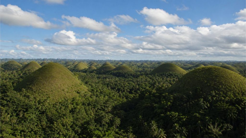 Panoramic view of the Chocolate Hills in Bohol surrounded by lush greenery