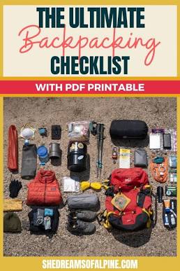 Hiker looking out over Philippine mountain ridgeline at sunrise with backpack gear laid out