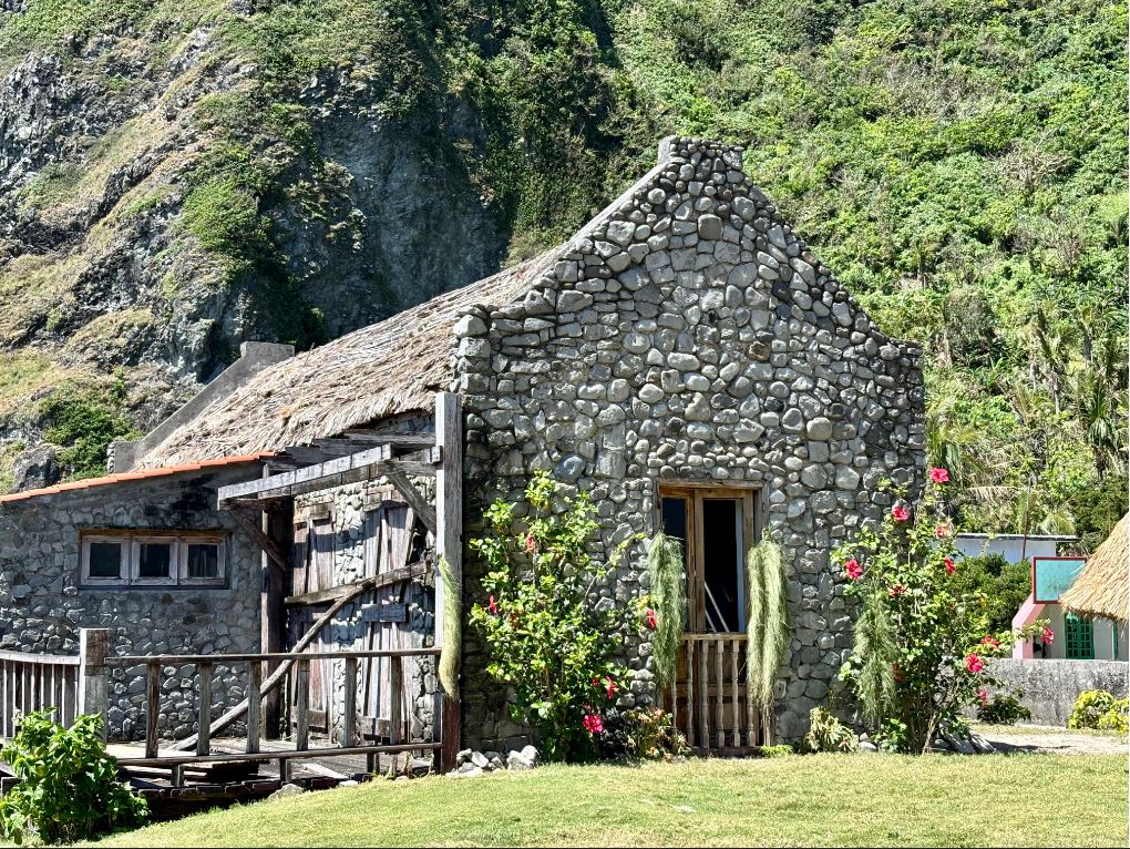 Historic Basco Lighthouse perched on Naidi Hills with panoramic views of Basco town and the Pacific Ocean in Batanes Philippines