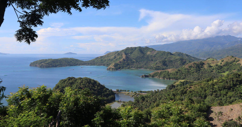 Panoramic view of Pujada Bay with the Sleeping Dinosaur island formation visible in the distance, Mati City, Davao Oriental.