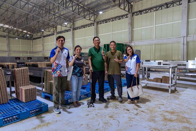Farm personnel standing inside a facility involved in biogas energy from manure and organic waste processing