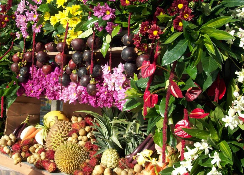 Fresh tropical fruits and colorful flowers displayed during the Kadayawan sa Dabaw Festival harvest celebration.