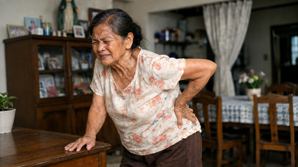 An elderly woman experiencing lower back pain, highlighting the need for osteoporosis therapy and proper bone health management.